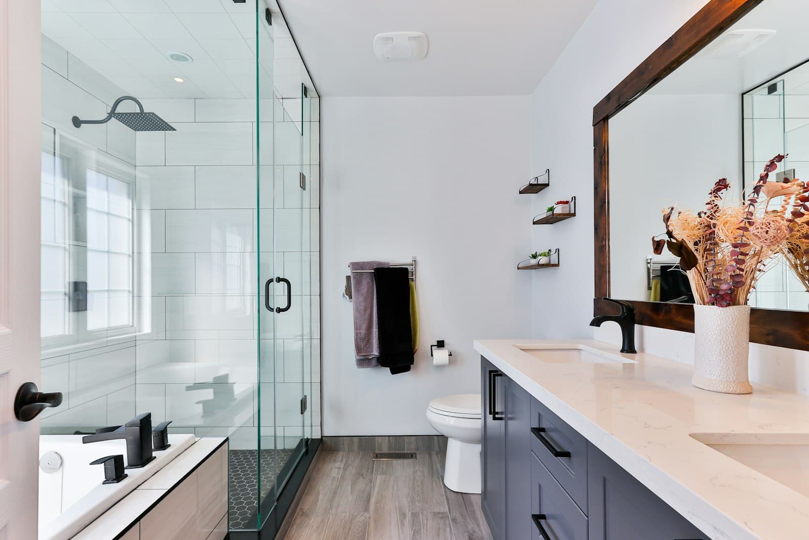 Renovated bathroom with glass shower and matte black fixtures