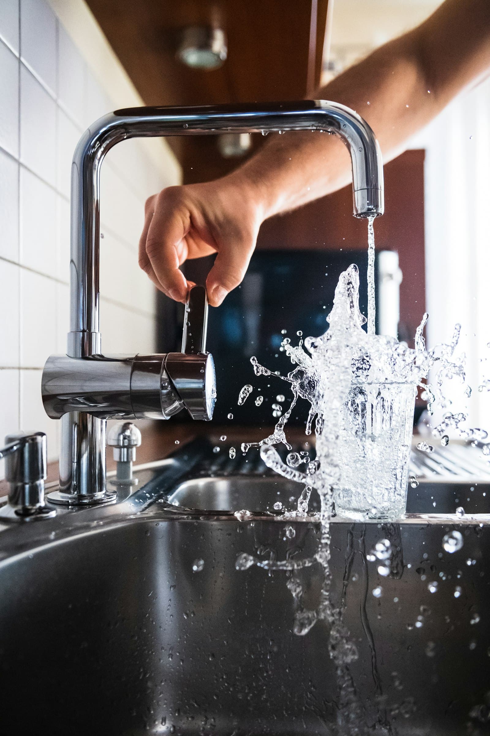 Kitchen faucet filling a glass of water