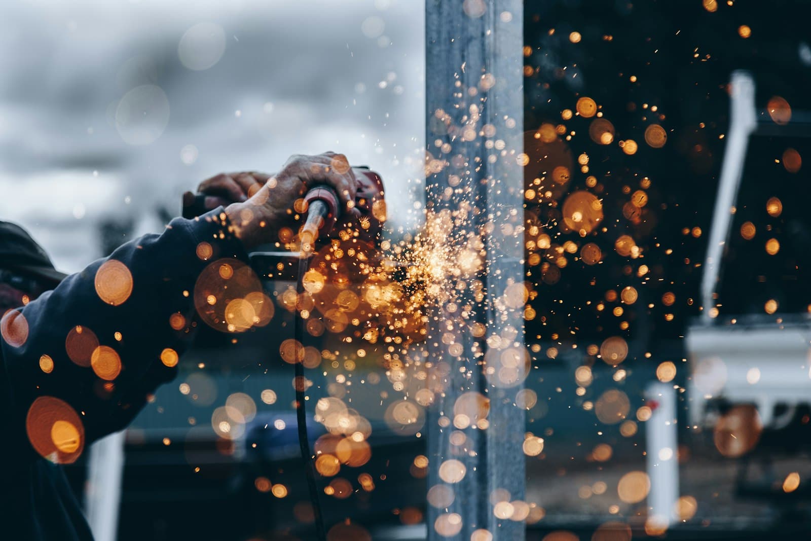 Cutting pipe with an angle grinder, sparks flying