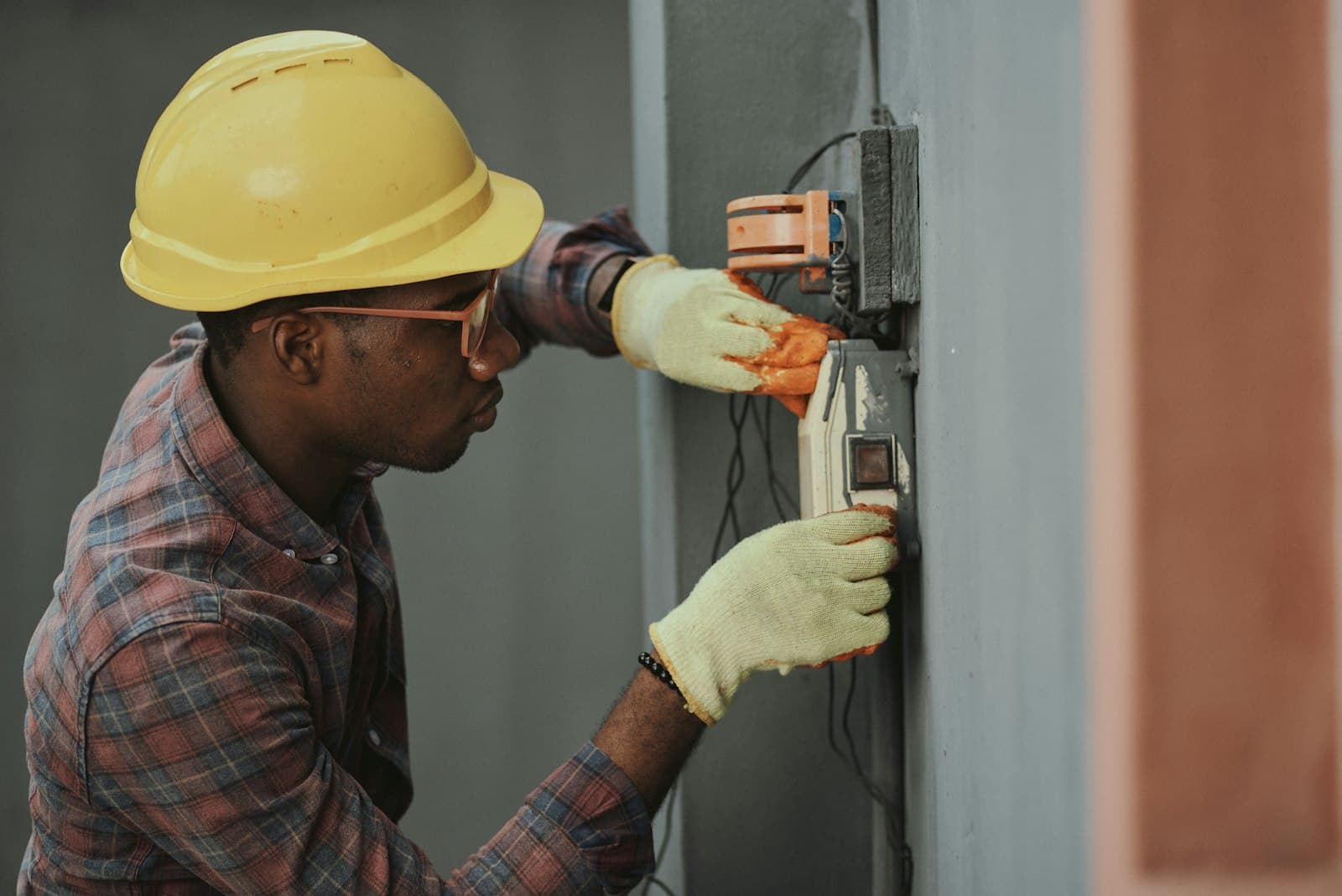Tradesman in a hard hat working on building systems